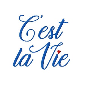 May include: Blue cursive text that reads "C'est la Vie" with a small red heart above the "e" in "Vie".