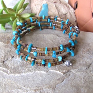 May include: A multi-strand bracelet with turquoise and brown beads. The bracelet is made of several strands of small, brown beads with larger turquoise beads interspersed throughout. The bracelet has a silver clasp.