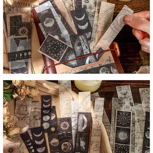 May include: A collection of vintage-style paper bookmarks with celestial and map-themed designs. The bookmarks feature illustrations of the sun, moon phases, and star charts in black and white. Some bookmarks have text, including the word "TIDES".