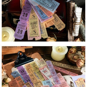 May include: A collection of vintage-style tickets in various colors, including purple, blue, and pink. Some tickets are tied together with twine. The tickets feature printed text and numbers, suggesting they are for travel or events.