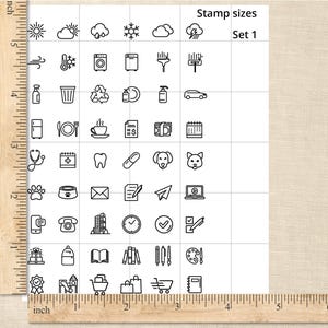 May include: A grid of black and white icon stamps, including weather symbols, household items, and various objects. The text "Stamp sizes Set 1" is at the top. A wooden ruler is on the left side, with inch measurements.