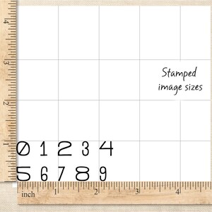 May include: A wooden ruler with inch markings and a grid background. Black numbers 0-9 are displayed. The text "Stamped image sizes" is also present.