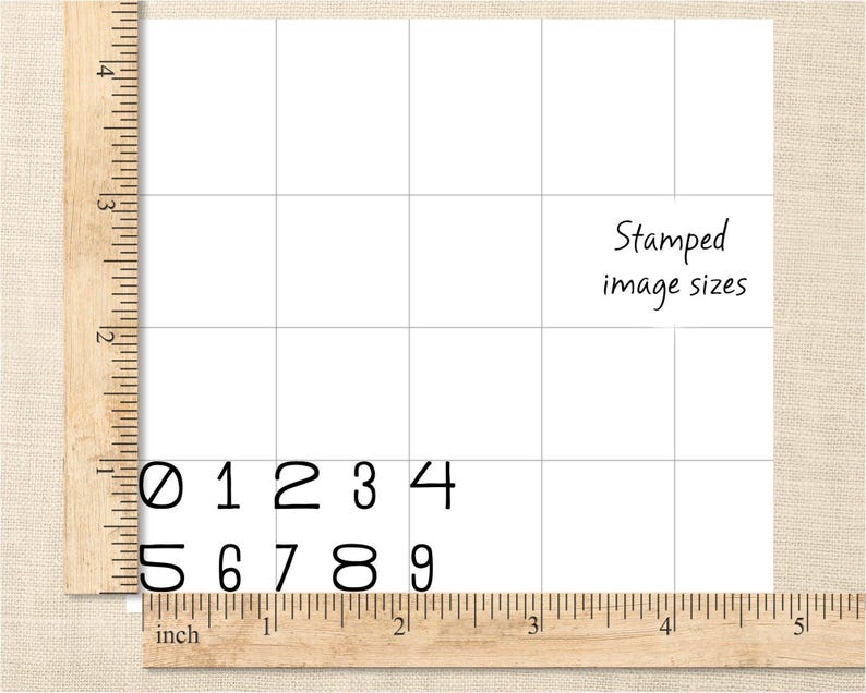 May include: A wooden ruler with inch markings and a grid background. Black numbers 0-9 are displayed. The text "Stamped image sizes" is also present.