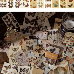 May include: A collection of vintage-style butterfly ephemera. The image shows a variety of butterfly illustrations in various colors, including orange, yellow, and brown, on aged paper. The text "Style 6" and "60 pc 50x80mm" is visible.