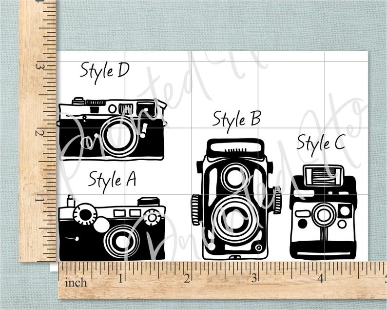 May include: Black and white illustrations of four vintage cameras, labelled Style A, B, C, and D. The cameras have different designs, including lenses, viewfinders, and flash attachments. The background features a grid pattern.