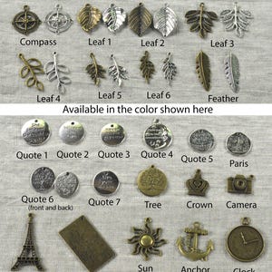 May include: A collection of charms in silver and bronze tones, including leaves, compasses, quotes, and other decorative elements. The image displays a variety of charm designs, such as a crown, camera, and Eiffel Tower, suitable for jewelry making or crafting.