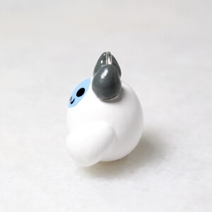 Side view of a yeti charm.