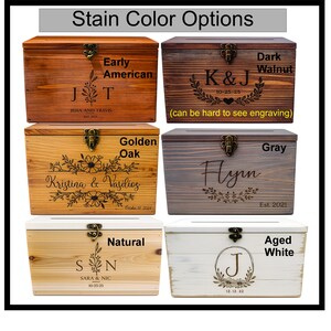 a collection of six wooden boxes, each with a unique stain color and personalized engraving. The boxes are arranged in a grid, showcasing the different color options available for the boxes.