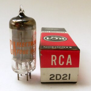 May include: A vintage RCA 2D21 vacuum tube in its original box. The tube is clear glass with a black metal top and the box is red with white lettering.