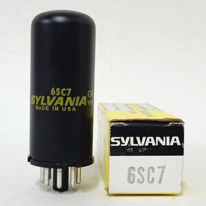 May include: A black Sylvania 6SC7 vacuum tube with a yellow and black box. The tube has the text "SYLVANIA MADE IN USA" in yellow. The box also has the Sylvania logo and "6SC7" printed on it.
