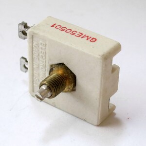 May include: A white ceramic potentiometer with a brass shaft and a red label that reads "GME6001".