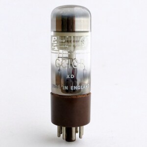 May include: A clear glass vacuum tube with a brown base and metal top. The tube has the text "E24" and "G.C.10" printed on it. The tube is labeled "XD" and "MADE IN ENGLAND".