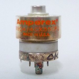 May include: A silver Amperex 8904/4CX350FJ vacuum tube with a clear glass top and a white ceramic base. The tube is labeled "Amperex" in orange lettering and "MADE IN U.S.A." in black lettering.