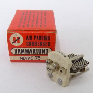 May include: A white ceramic air padding condenser with the text "MAPC-75" printed on it. The condenser is in its original box, which is red with white text that reads "Air Padding Condenser" and "HAMMARLUND".