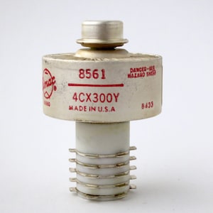 May include: A white ceramic 4CX300Y vacuum tube with a red label that reads "8561 4CX300Y MADE IN U.S.A." and "DANGER-HIGH HAZARD WHEN ENERGIZED 8433".