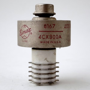 May include: A silver Eimac 4CX300A vacuum tube with a red label and the number 8167 printed on it. The tube is made in the USA.