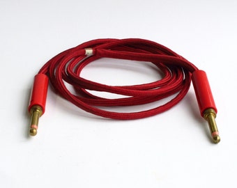 Red, cloth covered patch cable with solid brass plugs