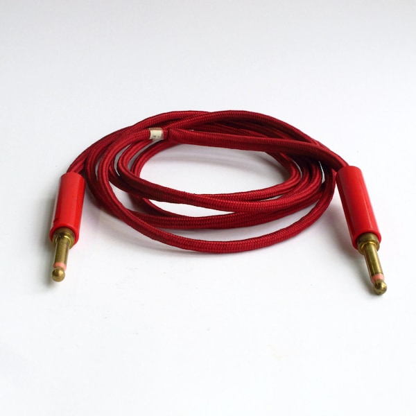 Red, cloth covered patch cable with solid brass plugs