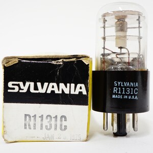 May include: A vintage Sylvania R1131C vacuum tube with a clear glass enclosure and black base, next to its original box. The box is black and white with the Sylvania logo and product information. Made in the U.S.A.