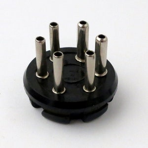 May include: Black plastic electrical connector with six silver metal prongs.