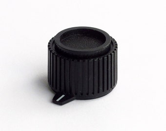 black radio knob with pointer and peeble-y top - and grips on sides - for 1/8" shafts