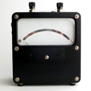 May include: A black analog meter with a white face and a needle pointing to the right. The meter is labeled "Weston Electrical Instrument Corp. Newark, N.J. U.S.A."