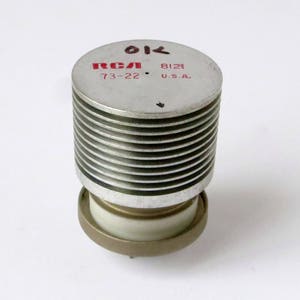 May include: A silver RCA 73-22 vacuum tube with a ribbed heat sink and the text "RCA 73-22 8121 U.S.A." printed on the side.