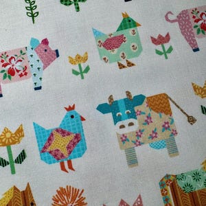May include: White fabric with a repeating pattern of stylized farm animals and flowers. The animals include a pig, cow, horse, and chicken, each with floral patterns. The flowers are in shades of pink, yellow, and orange.
