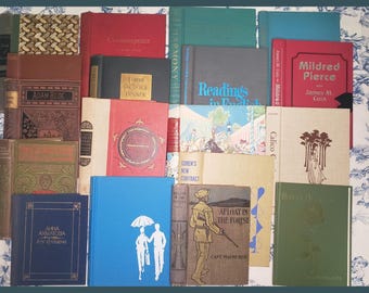 May include: A collection of vintage hardcover books with various titles and authors. The books are arranged in a vertical stack, with the spines facing outward. The books are in various colors, including red, blue, green, and brown. The books are all in good condition, with no visible damage or wear.