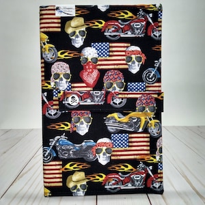 May include: Black fabric wallet with a repeating pattern of American flags, flames, skulls wearing sunglasses and bandanas, and motorcycles. The text "Wookie Wishes" is printed on the wallet.