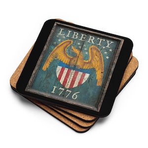 May include: A stack of square coasters with a patriotic design. Each coaster features a distressed image of an eagle, shield, and the text "LIBERTY 1776" in a wooden frame. The coasters have a black border and a cork backing.