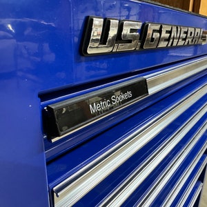 May include: A blue metal toolbox with a silver U.S. General logo and a drawer labeled "Metric Sockets".