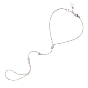 May include: A silver chain bracelet with three small clear stones. The bracelet is designed to be worn around the wrist and has a long chain that hangs down to the fingers.