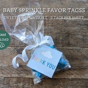 May include: Printable baby shower favor tags with a blue cloud and raindrops design. The tags say "Thank You" in rainbow letters. There are 9 tags per sheet.
