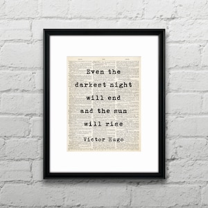 May include: Black and white typography print with the quote "Even the darkest night will end and the sun will rise" by Victor Hugo. The quote is printed on a vintage book page background.
