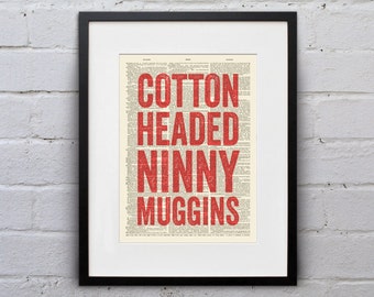 May include: A framed print of the phrase "Cotton Headed Ninny Muggins" in red text on a vintage dictionary page background.