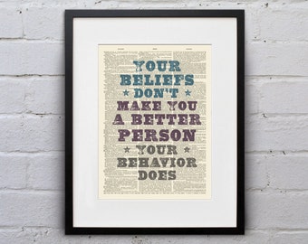 May include: A framed print with a quote on a vintage book page background. The quote reads "Your beliefs don't make you a better person. Your behavior does."