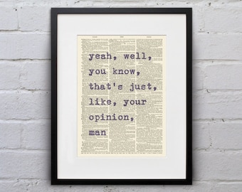 May include: Framed art print featuring the quote "yeah, well, you know, that's just, like, your opinion, man" in purple text. The background is a vintage dictionary page. The print is in a black frame with a white mat.