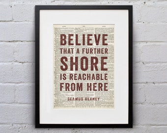 May include: A framed print of a quote by Seamus Heaney on a vintage dictionary page background. The quote reads "Believe that a further shore is reachable from here".