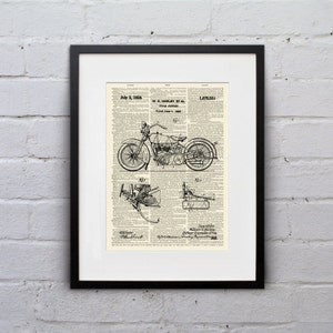 May include: Framed black and white motorcycle patent print. The print features detailed technical drawings of a motorcycle, along with text including "July 3, 1928" and "W.S. Harley et al". The background is a vintage newspaper page.