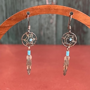 May include: A set of three ceramic mugs with a speckled, matte finish. The mugs are in shades of cream, light gray, and dark gray. Each mug has a simple, minimalist design and a rounded handle.