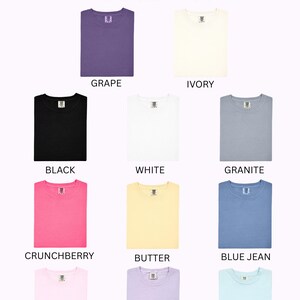 May include: Image showcasing a variety of t-shirt color options. Colors include grape, ivory, black, white, granite, crunchberry, butter, blue jean, pink, orchid, and light blue. The Honey Boutique logo is at the top.