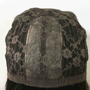 May include: A black lace wig cap with a brown elastic band around the edge.