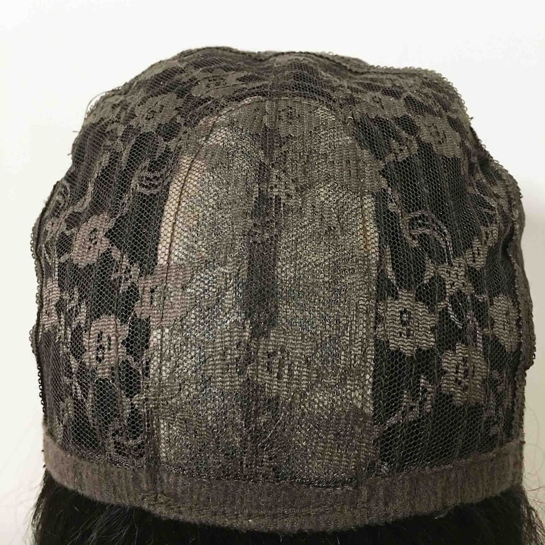 May include: A black lace wig cap with a brown elastic band around the edge.