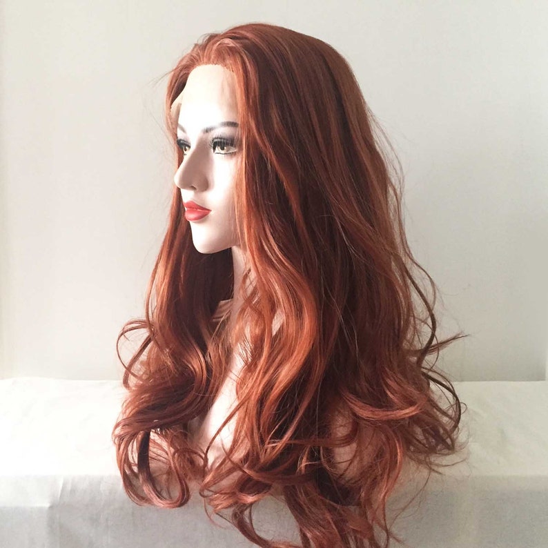 May include: A long, wavy auburn wig on a mannequin head. The wig features a lace front and a natural-looking hairline. The hair is a rich, reddish-brown color with subtle highlights, and the style is voluminous and flowing.