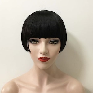 May include: A black bob wig with a straight, blunt cut. The wig is styled with a fringe and has a natural, realistic look.