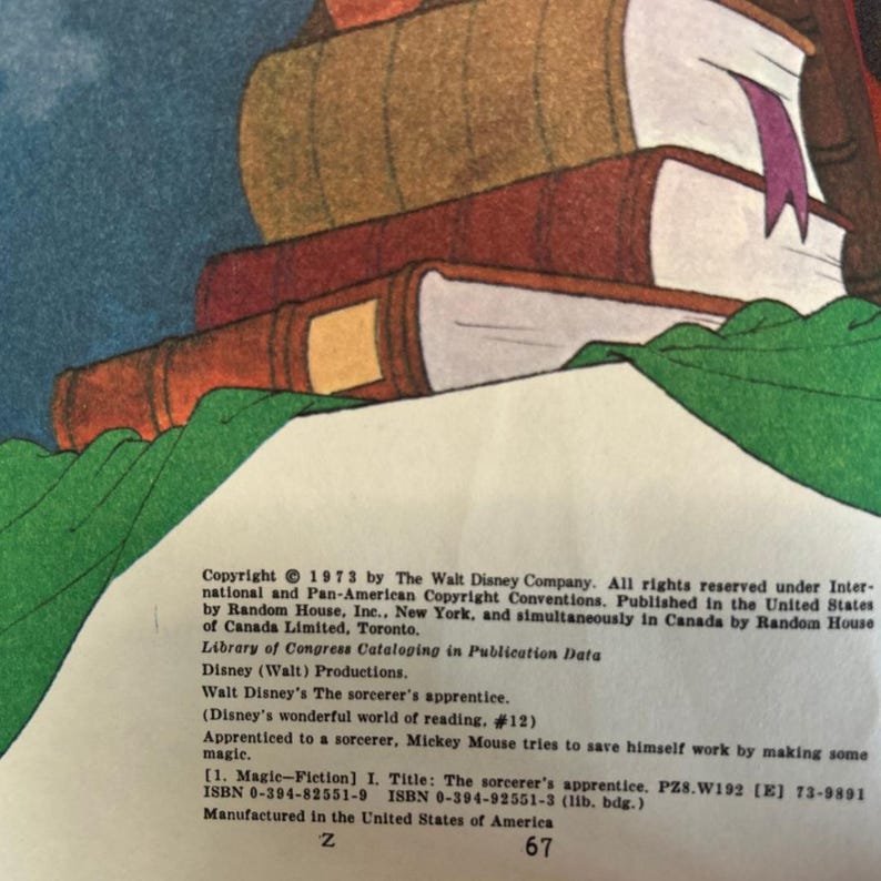 May include: A stack of vintage books with brown, red, and tan covers. The top book has a purple ribbon bookmark. The image includes text from the book, including the copyright information from 1973 by The Walt Disney Company.