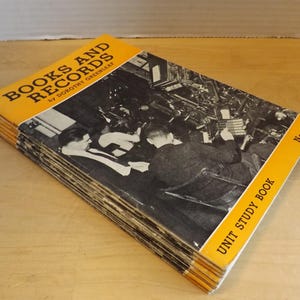 May include: A vintage book titled "Books and Records" by Dorothy Greenleaf. The cover is yellow with black text and a black and white image of people working. The book is a unit study book, with the number 613 on the cover.