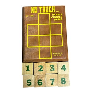 May include: A wooden Parris Puzzle Game board titled No Touch with a yellow grid and text. Below the board are eight individual wooden blocks, each featuring a green number from one to eight, arranged in two rows of four blocks each.