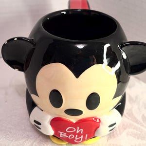 May include: A handmade wooden sign with the text "Welcome" in a playful font. The sign features a distressed white background and a dark brown frame, perfect for a front door or entryway. The sign measures approximately 12 inches wide and 6 inches tall.